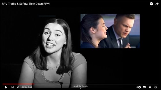 Young girl in foreground with image of two adults in background