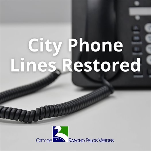 An office phone rests on a desk. A headline above the City of Rancho Palos Verdes logo says City Phone Lines Restored.