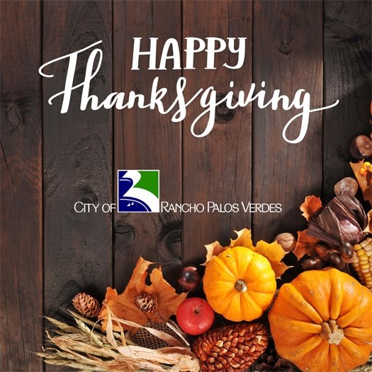 Pumpkins, fall leaves, and corn decorate a table for Thanksgiving. A headline above the City of Rancho Palos Verdes logo says Happy Thanksgiving.