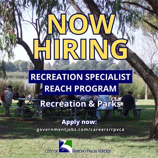 Participants in the City of Rancho Palos Verdes' REACH program, which serves youths and adults with developmental disabilities, gather in a park. A headline above the City of Rancho Palos Verdes logo says Now Hiring. Subheads say Recreation Specialist: REACH Program, Recreation and Parks. Apply now: governmentjobs.com/careers/rpvca